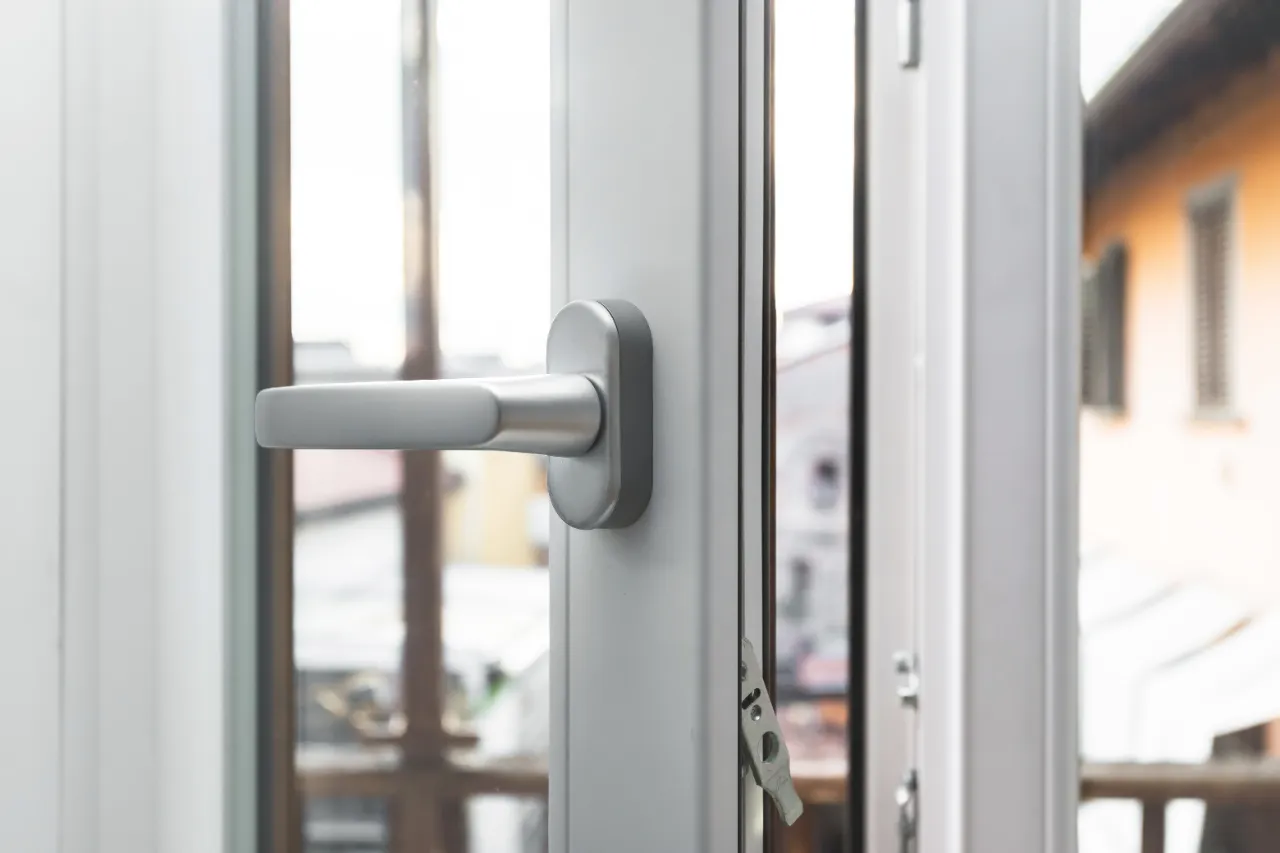 modern-window-with-silver-handle-view-of-building-2026-03-17-00-37-02-utc