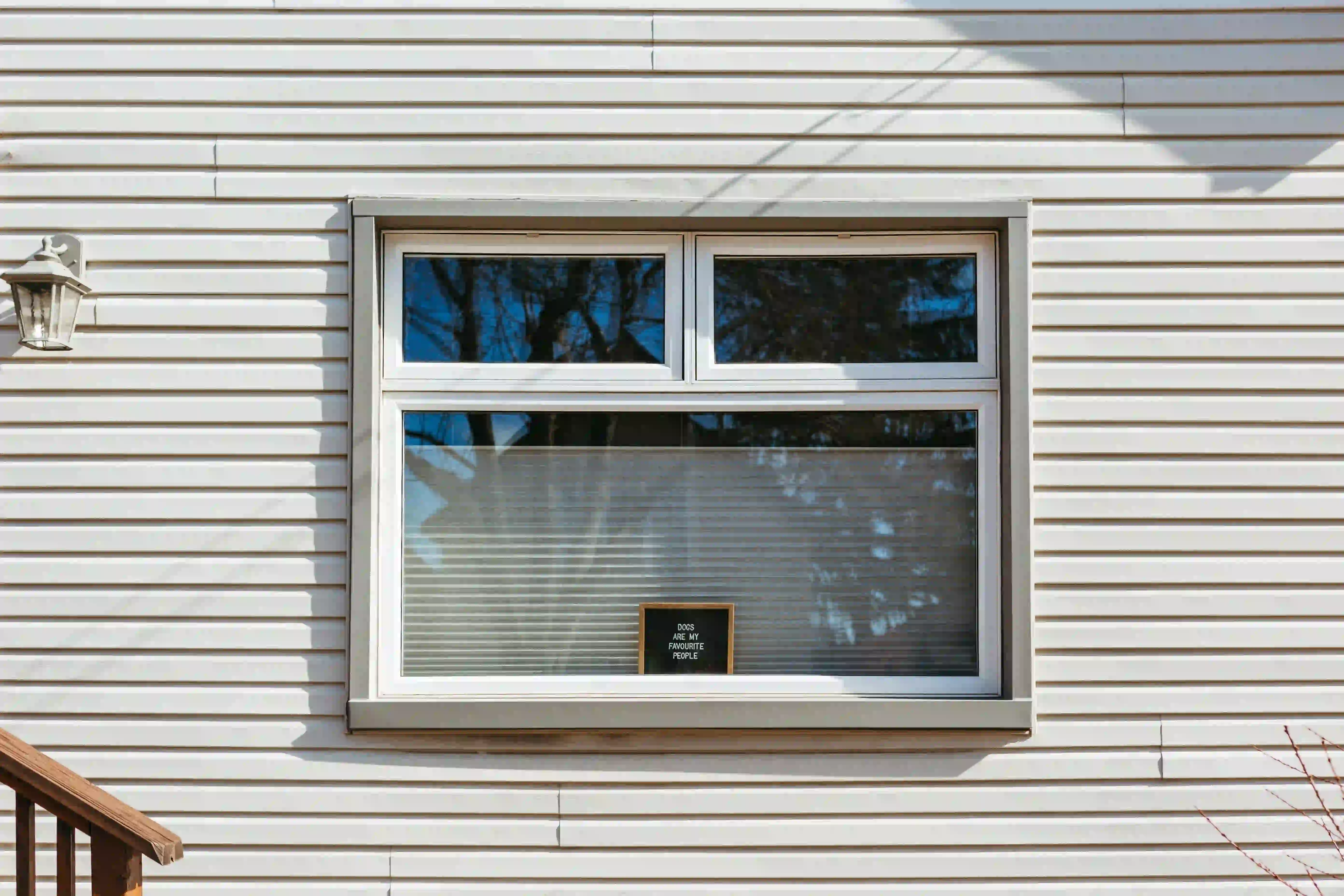 Window in exterior wall of Massachusetts house during siding project